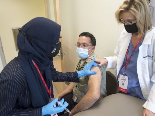 A patient receiving a COVD-19 vaccination